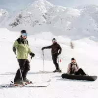 Skieurs et snowboardeuse profitant d’une journée ensoleillée sur le domaine skiable des Arcs