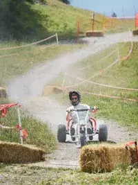 A mountain kart driver taking a bend on a track at Les Arcs